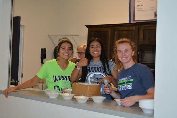 Students serving ice cream.