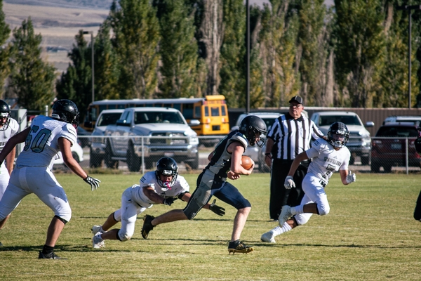 Football player running with football.